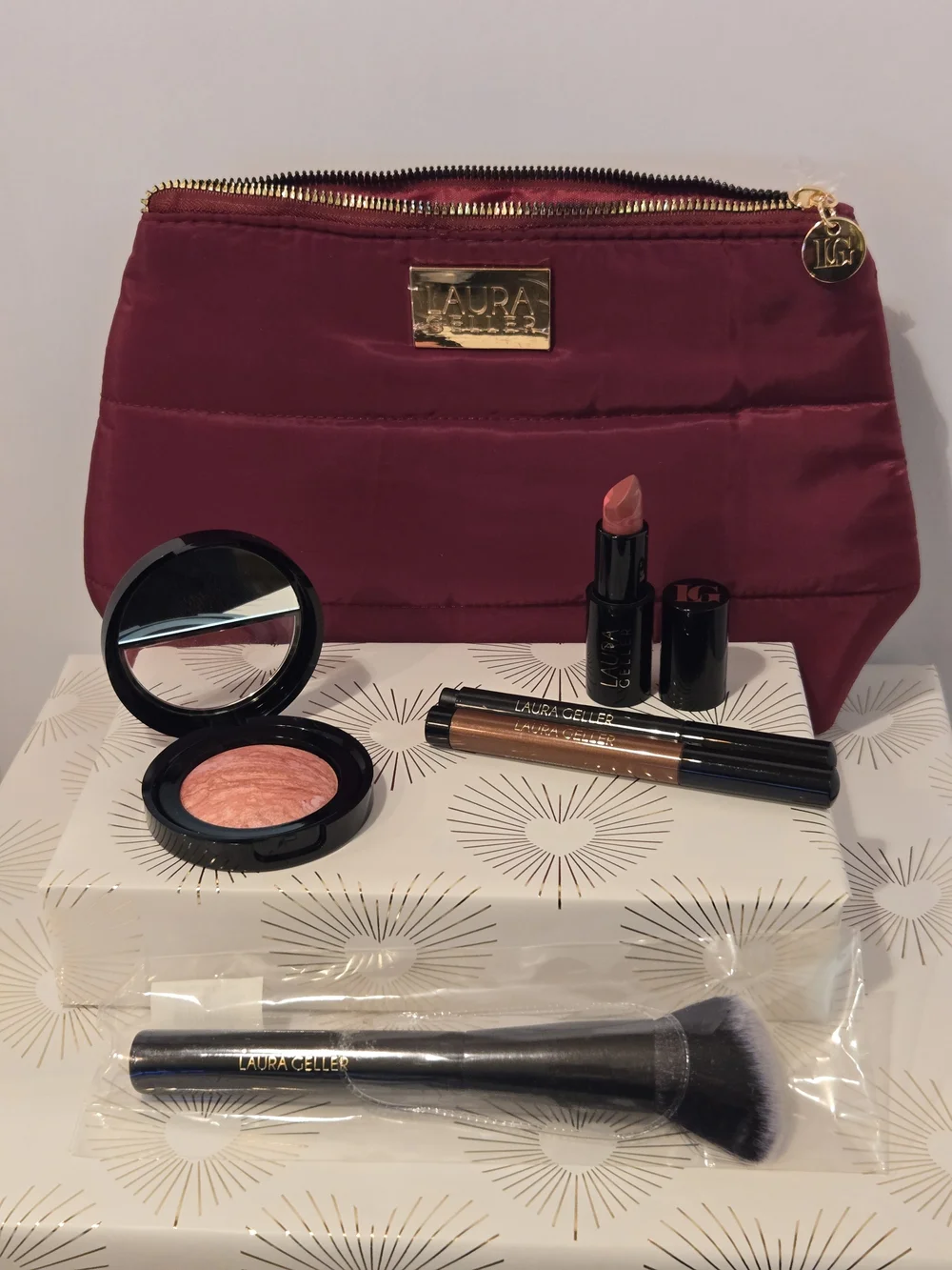 Laura Geller Makeup Bundle With Wine Quilted Cosmetic Pouch.
